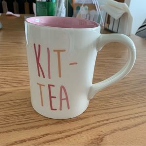 White ceramic coffee mug with “KIT-TEA” lettering